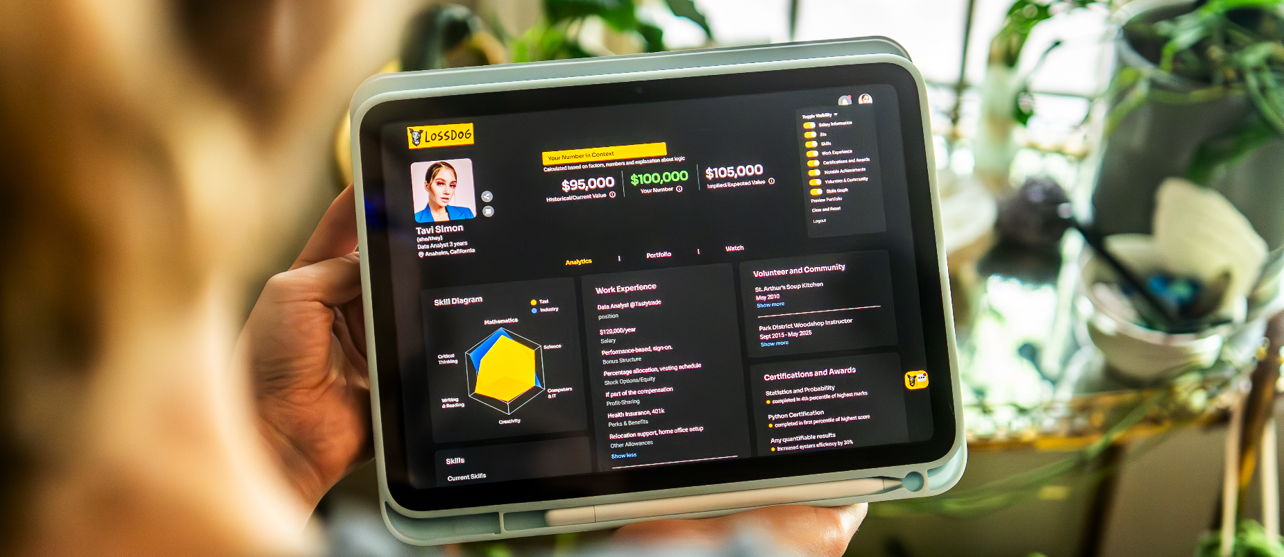 person holding ipad with a profile showing professional worth platform